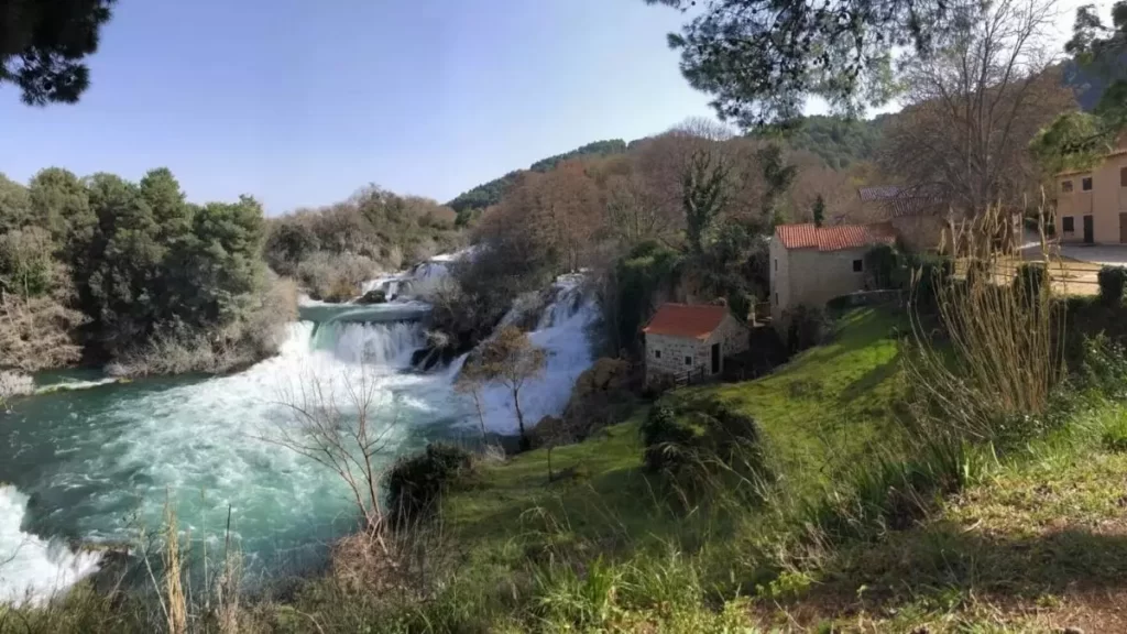 Image of Croatian river flowing next to a village