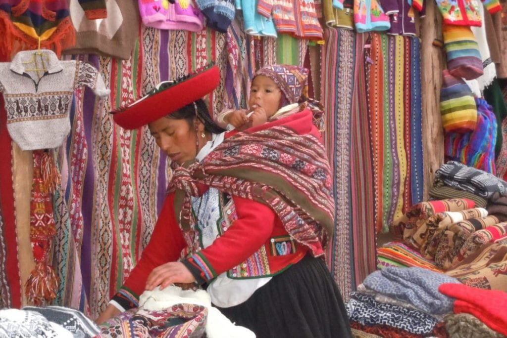 Chinchero Woman carrying a baby on her back